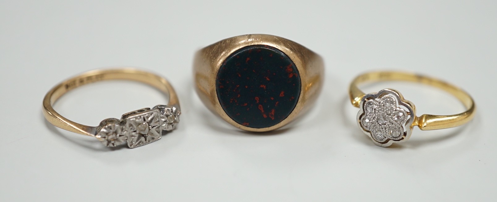A 1920's 18ct and diamond chip set cluster ring, size N, gross 2.4 grams and two 9ct rings including bloodstone set signet, gross 7.2 grams.